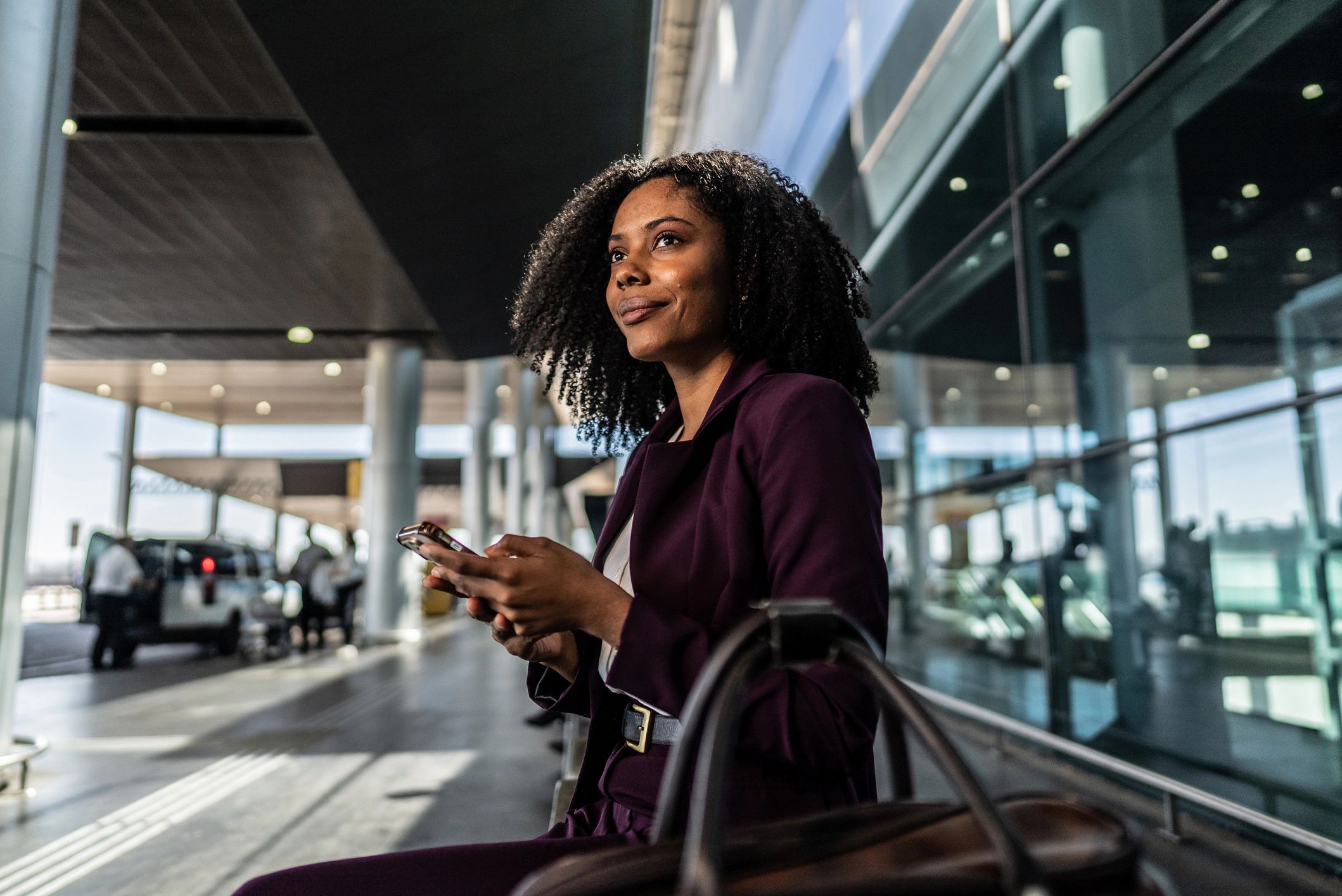 Traveler using a phone at the airport while arranging transportation