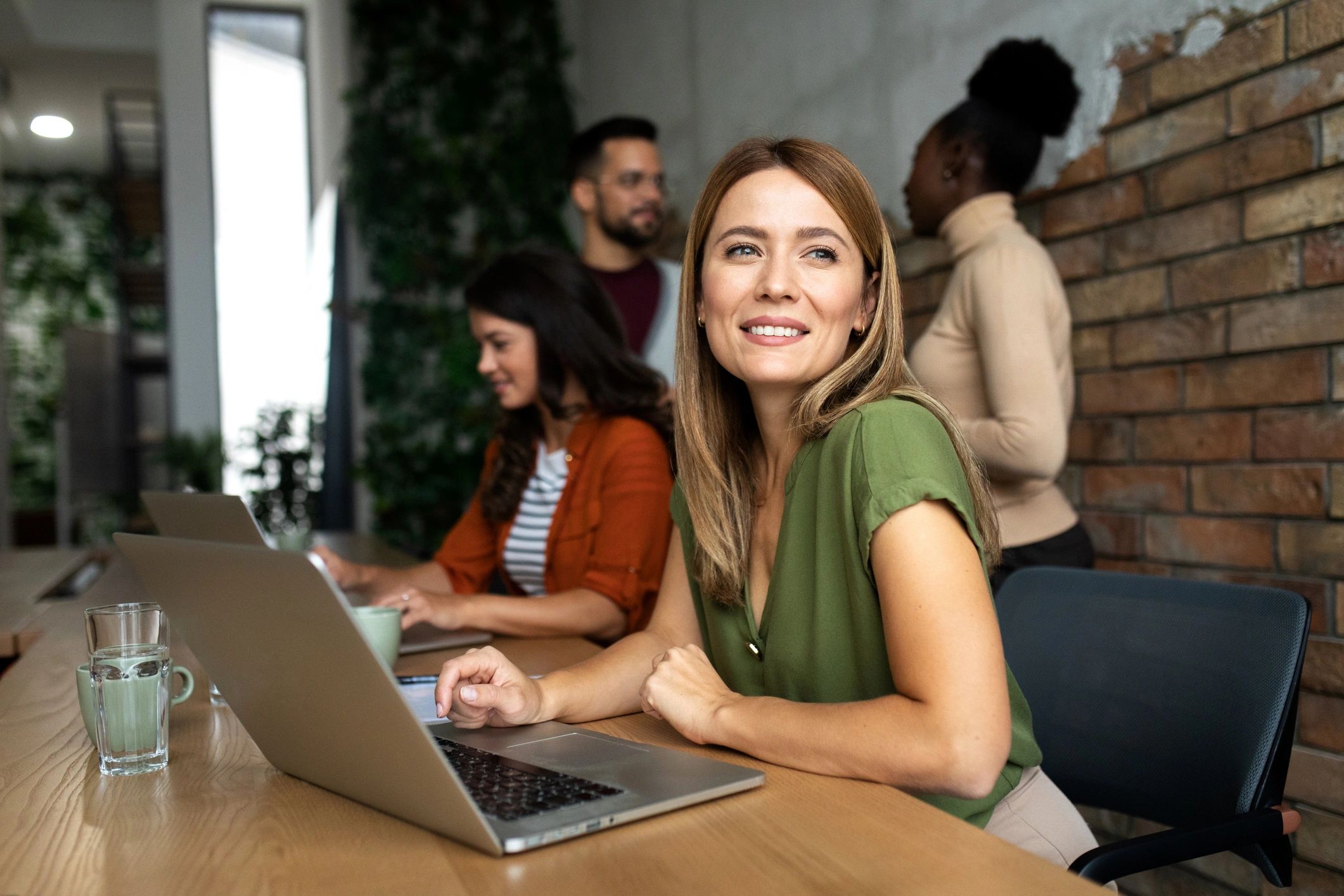 Team members assisting travelers via laptop and phone