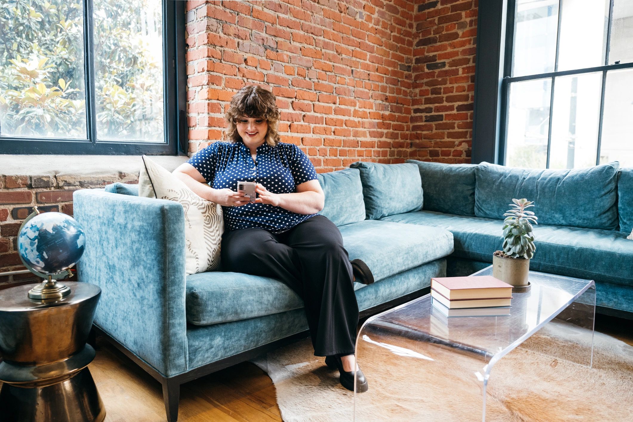 Business woman using phone in office lounge
