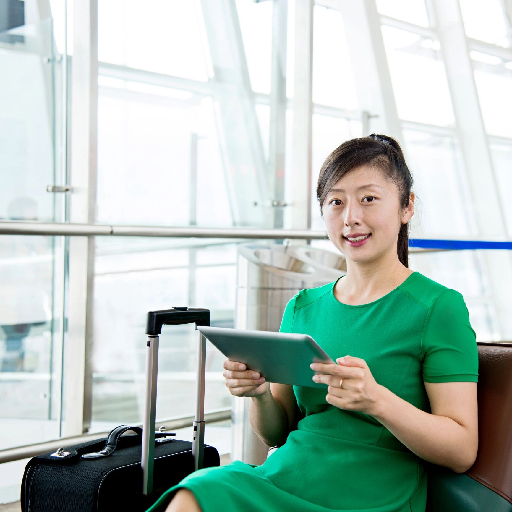 Portrait of a traveler using a tablet in an airport