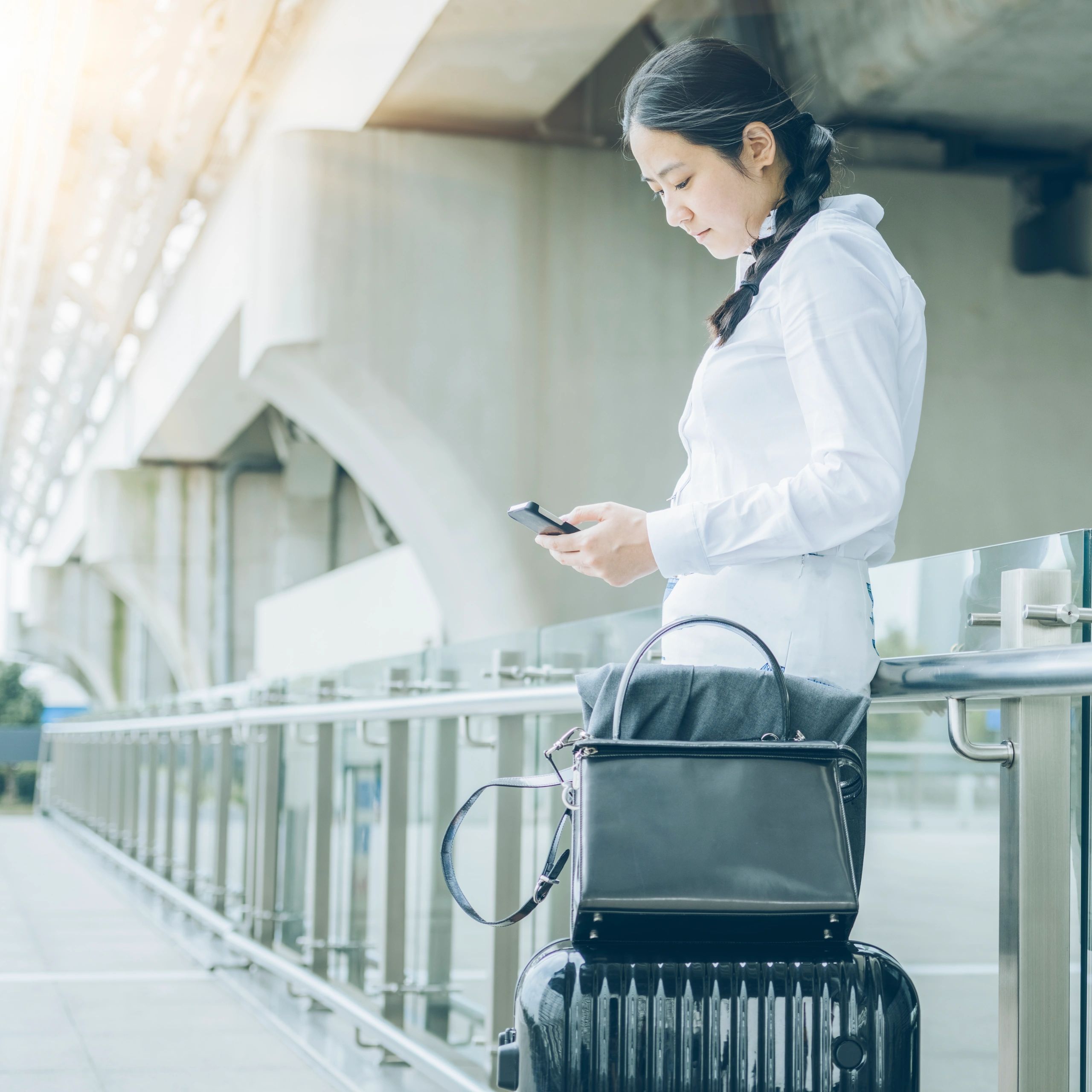 Portrait of a business traveler using a phone